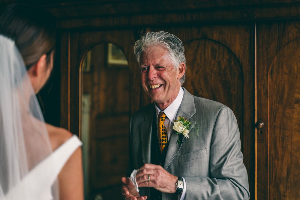 Micro weddings in 2020. Father of bride beams with happiness at his daughter ready to get wed