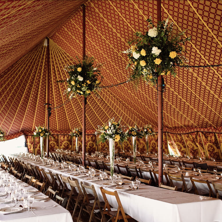 boho marquee for festival weddings with patterned inside and tables laid out for a reception