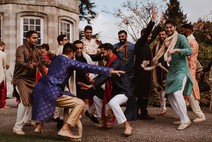 Dancing baraat party at indian wedding venue in the cotswolds