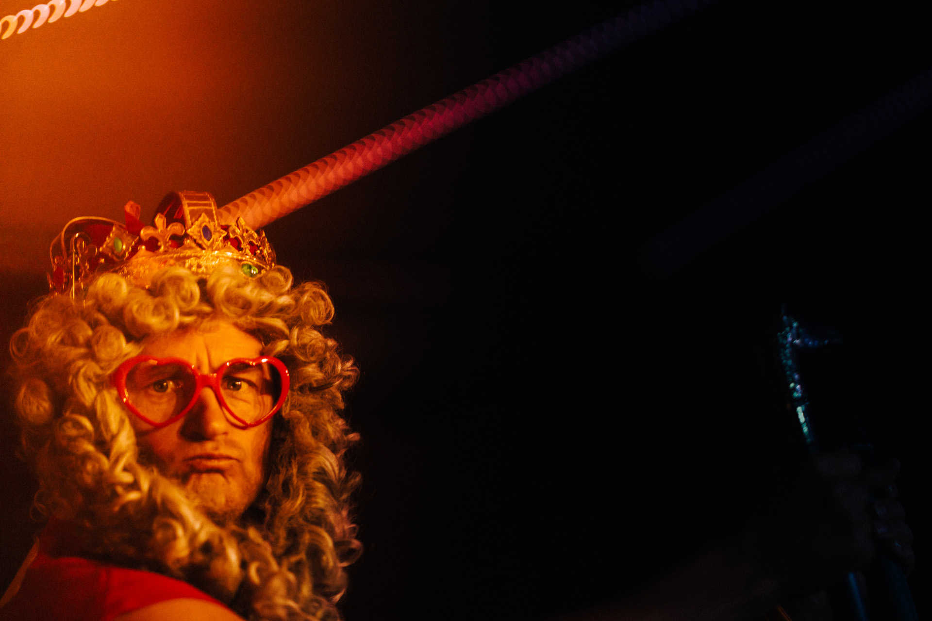 Live music with added dressing up- front man waers curly wig and heart shaped glasses