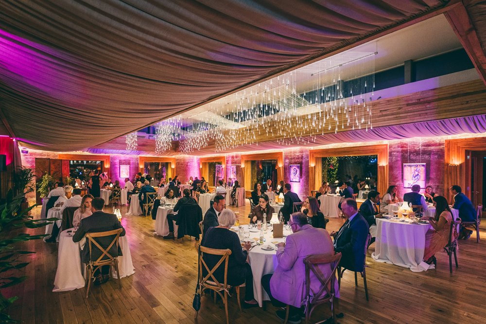 The Parrot cage cabaret dining event beautiful round tables set up amid twinkling lights