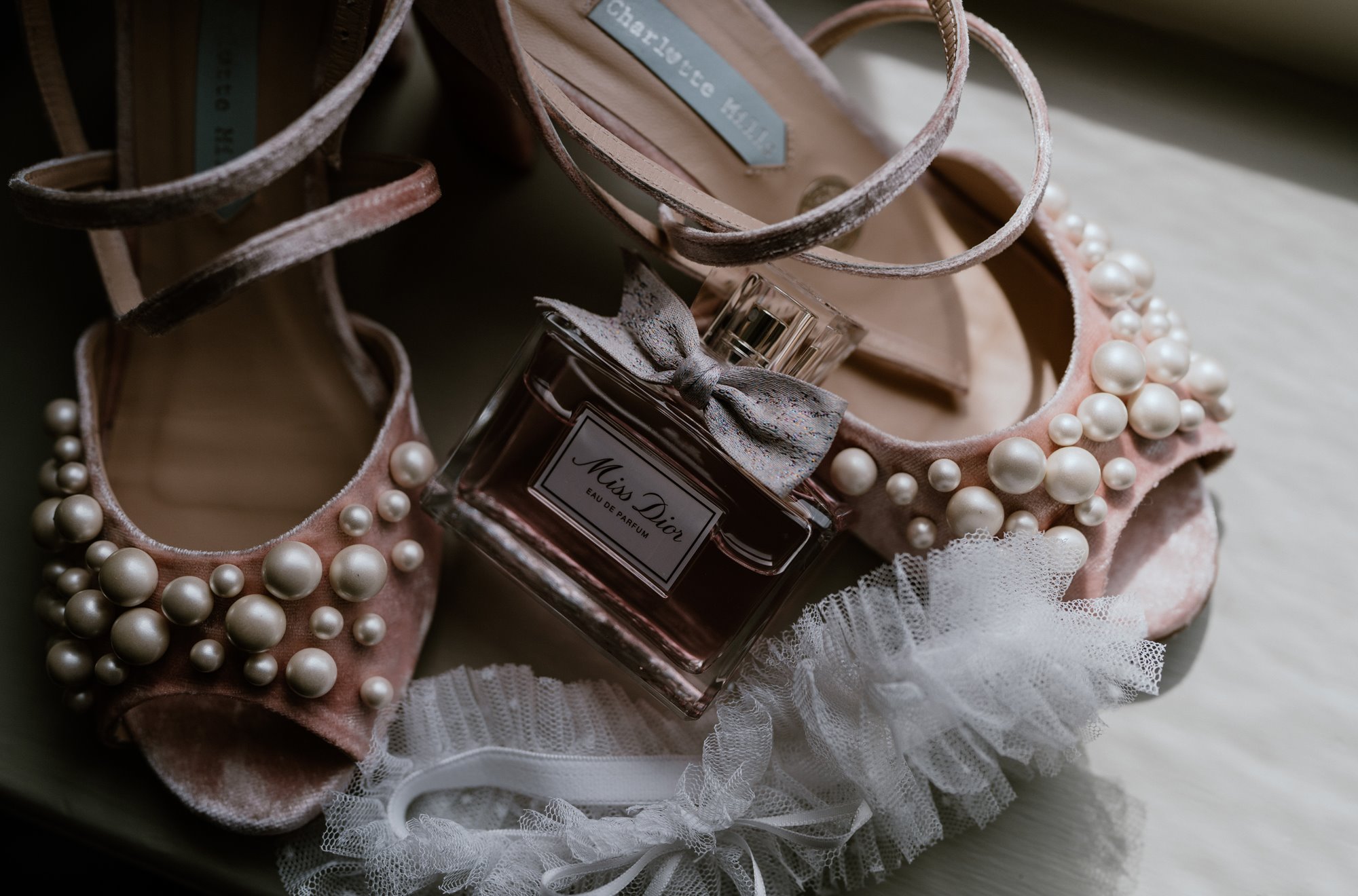 stunning bridal accessories including heels adorned with pearls, sweet fragrances and a lacy wedding garter