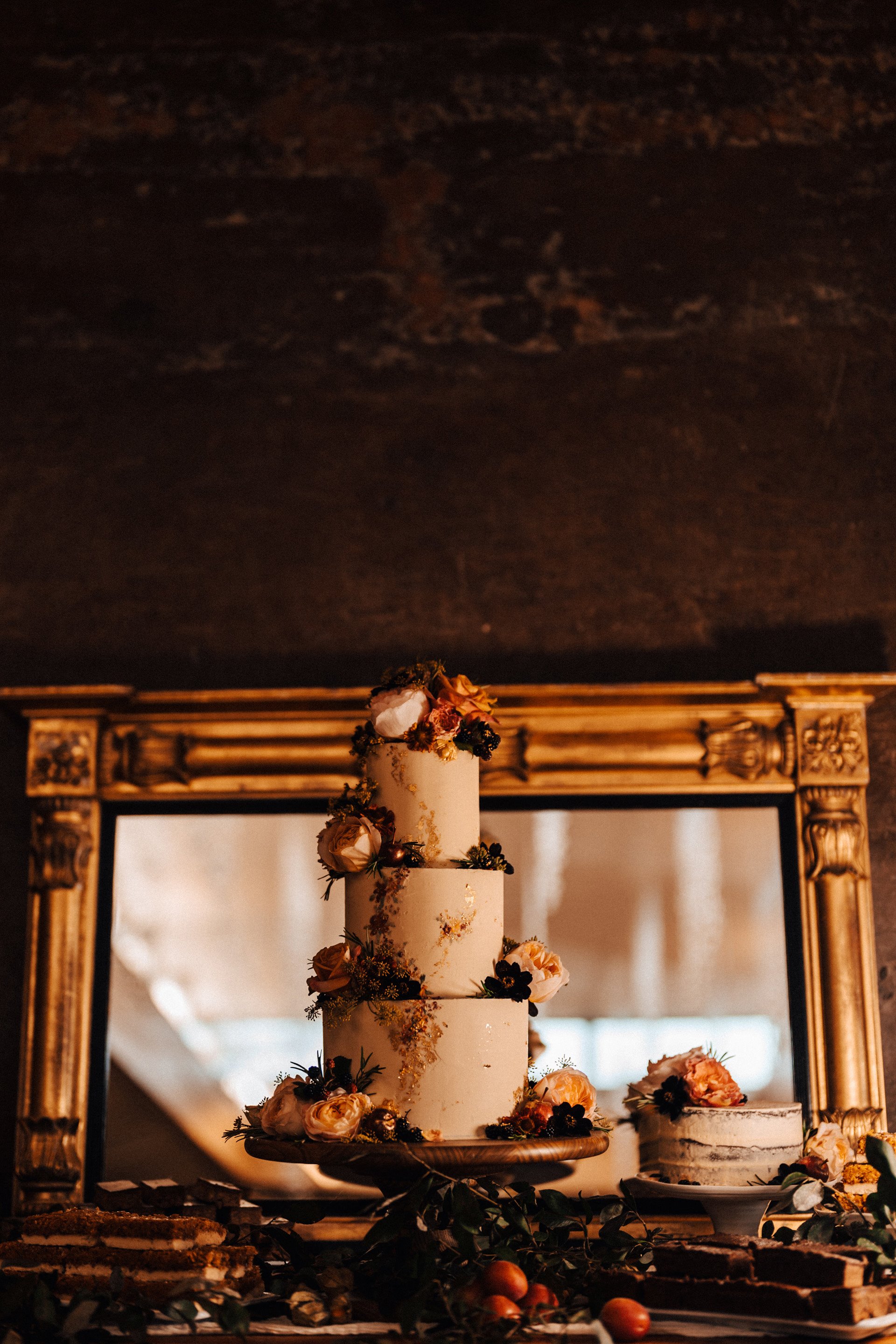 Wedding cake with real flowers for September wedding at sustainable wedding venue