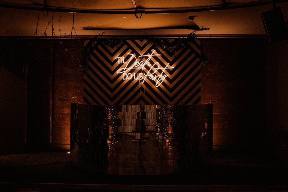Till death so us party wedding sign lights up the dance floor at soundproof party venue in Cotswolds