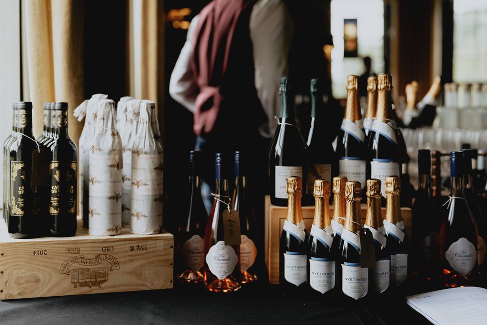 sommelier giving wine advice and tasters at wedding fair in the cotswolds