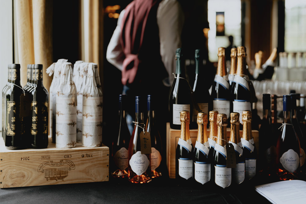 sommelier giving wine advice and tasters at wedding fair in the cotswolds