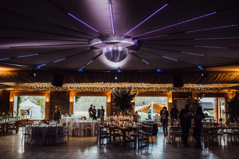 Soundproof party wedding reception venue with dining space with magical lights, dance floor and disco lighting