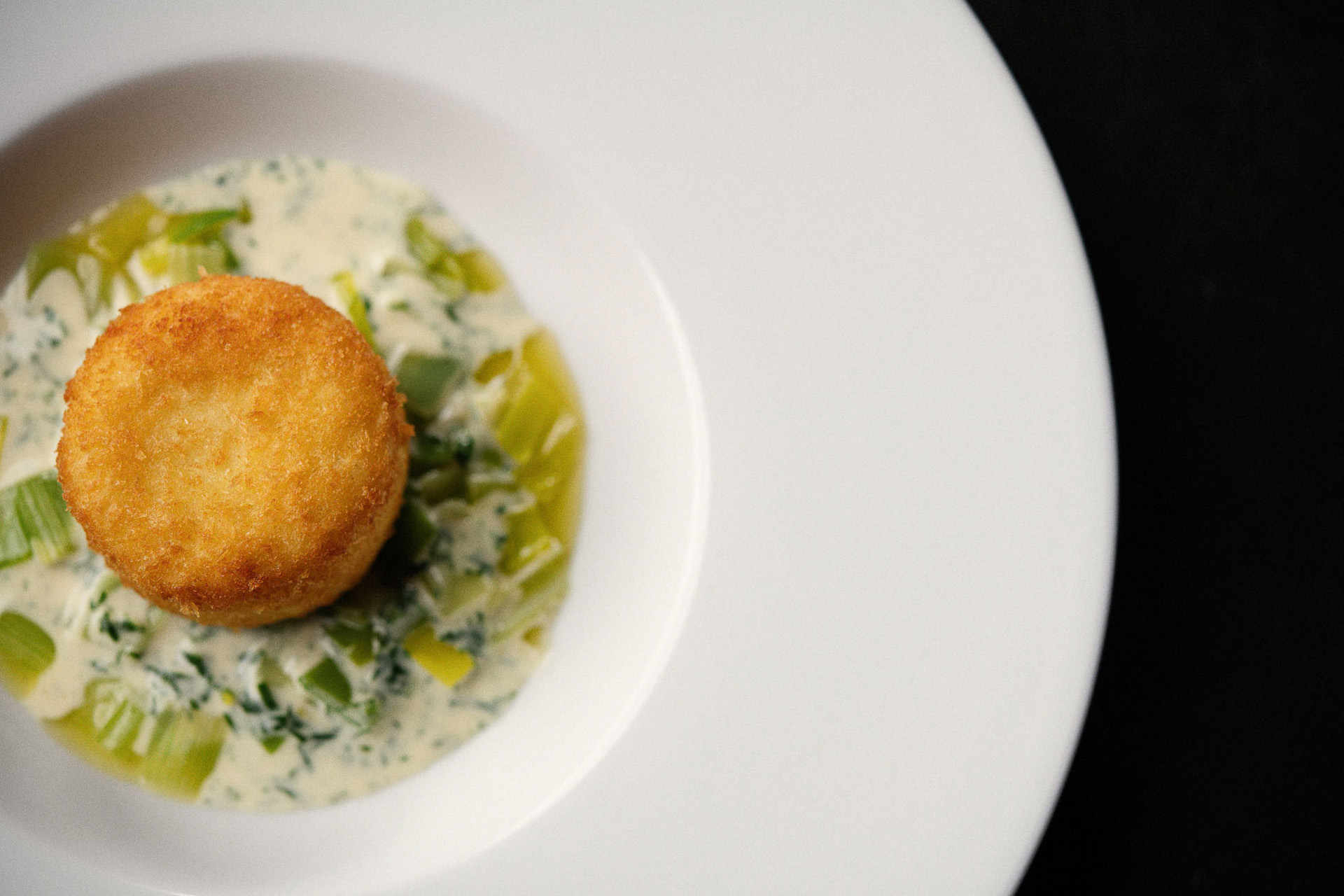 Wedding food. Haddock fishcake, braised leeks, white wine & tarragon cream