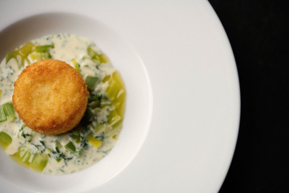 Wedding food. Haddock fishcake, braised leeks, white wine & tarragon cream