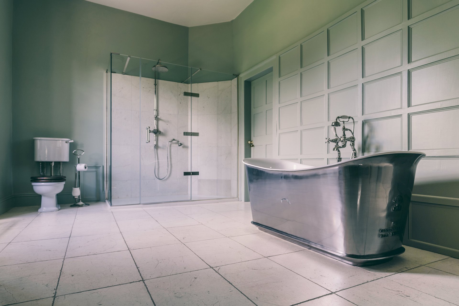 Huge bathroom with free standing silver bath tub in the bridal suite at wedding venueelmore court