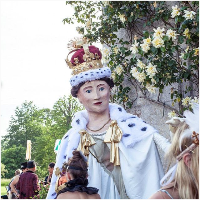 Giant puppet of the queen for jubilee inspired festival wedding in the gardens of elmore court in gloucestershire