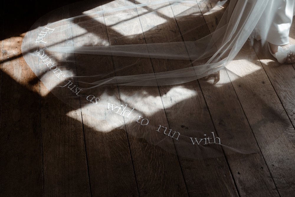 WIld wedding inspiration bridal wear for boho luxe wild brides. Veil embellished with the words 'find someone just as wild to run with'