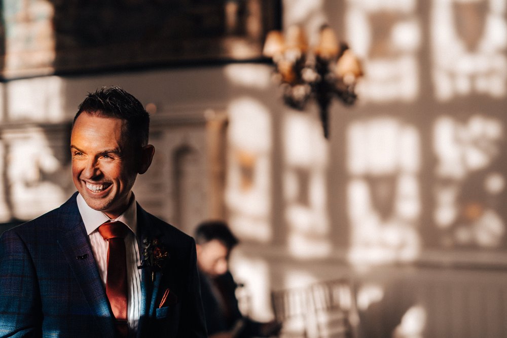 groom waiting for his bride in beautiful ceremony hall