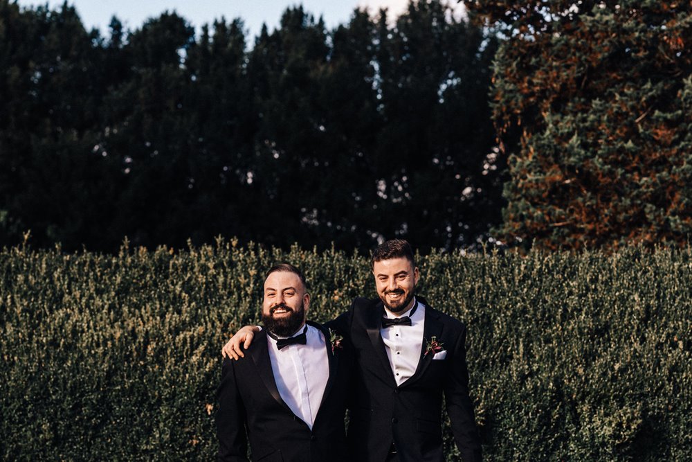 grooms in black tuxedos for moody autumn wedding in october at elmore court