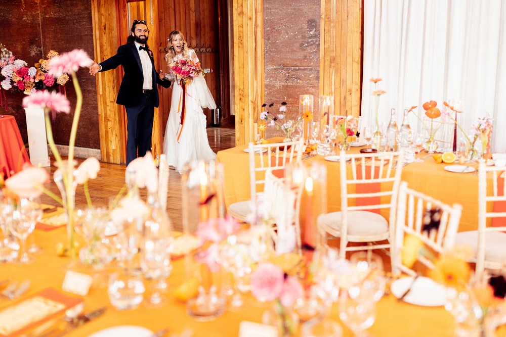 Cool bride and groom see their colourful wedding reception for the first time