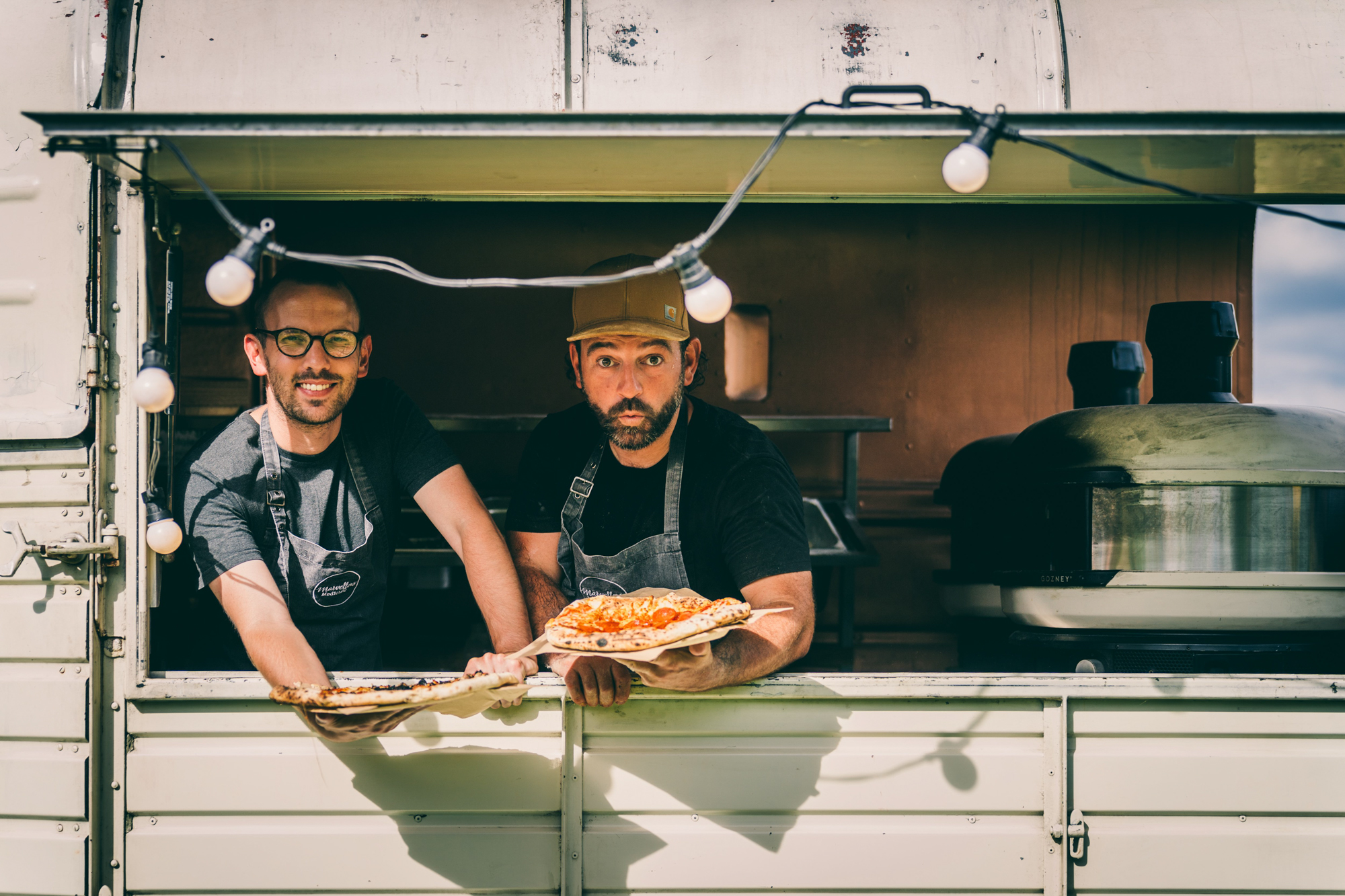 Wedding pizza from a cool truck with light up sign at wedding fair in the cotswolds