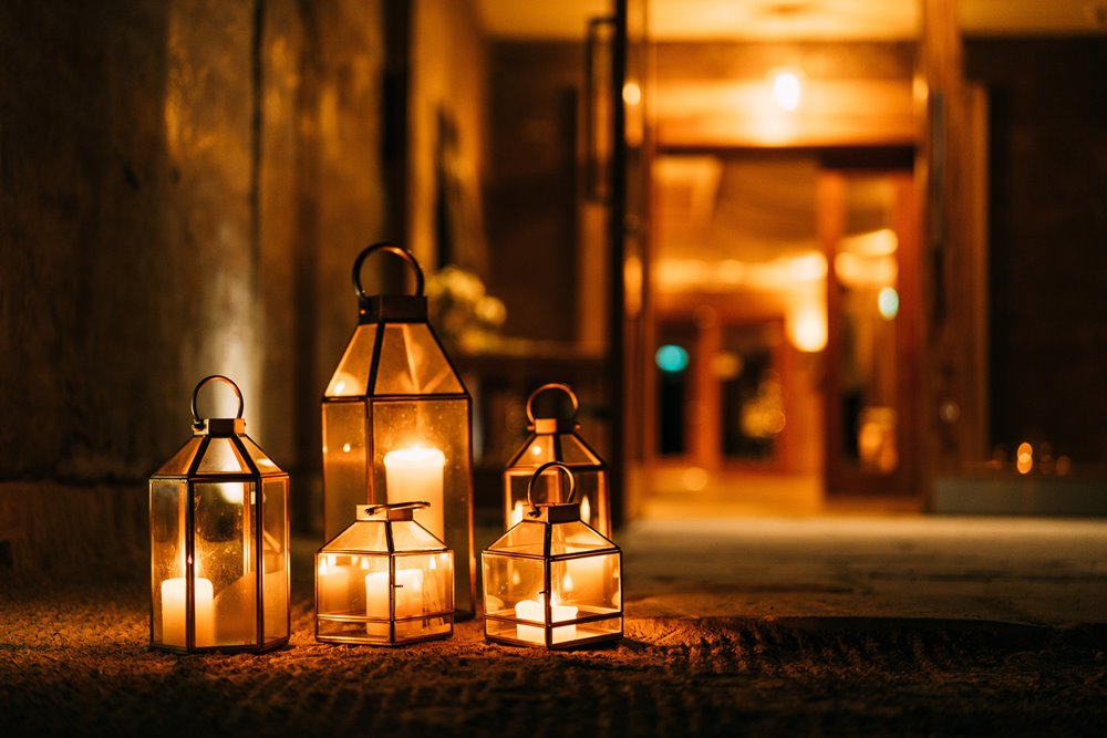 Candle lanterns outside wedding reception at a Christmas wedding in the gllyflower at elmore court