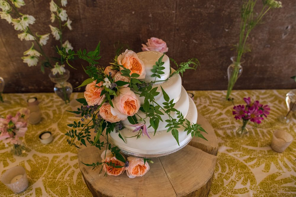 Garden party wedding cake with real roses for a same sex wedding at elmore court