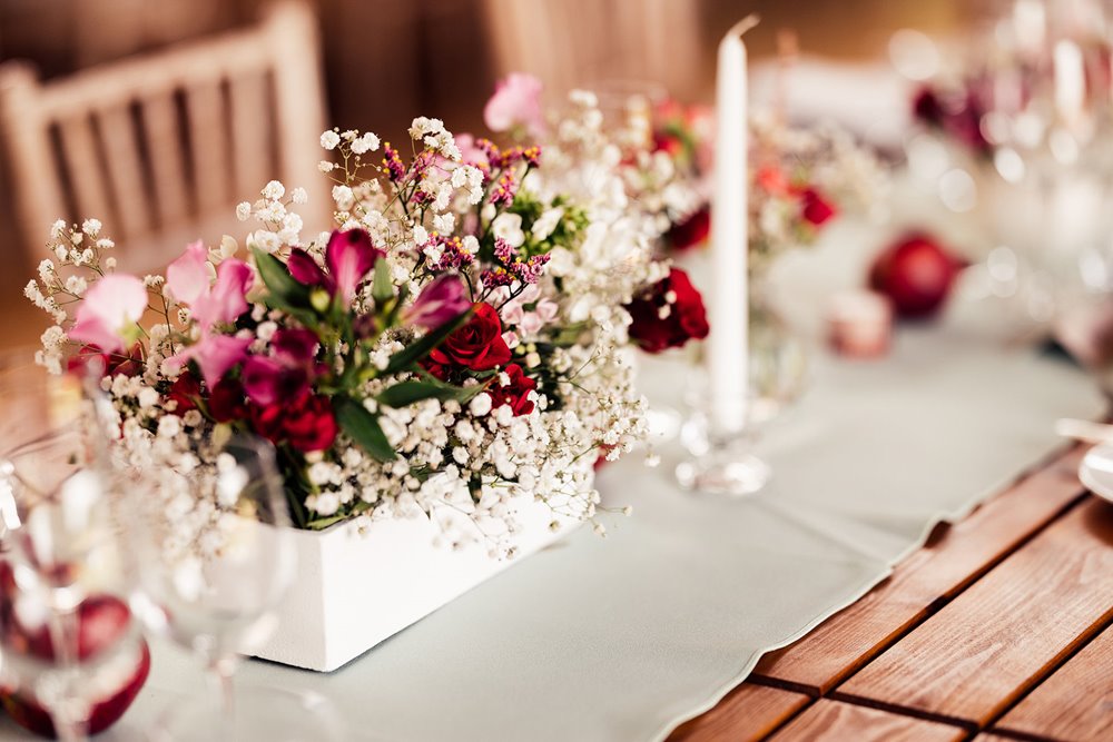 delicate pink and red flowers on tables for wedding reception
