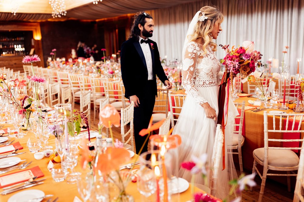 Cool bride and groom see their colourful wedding reception for the first time in the cotswolds