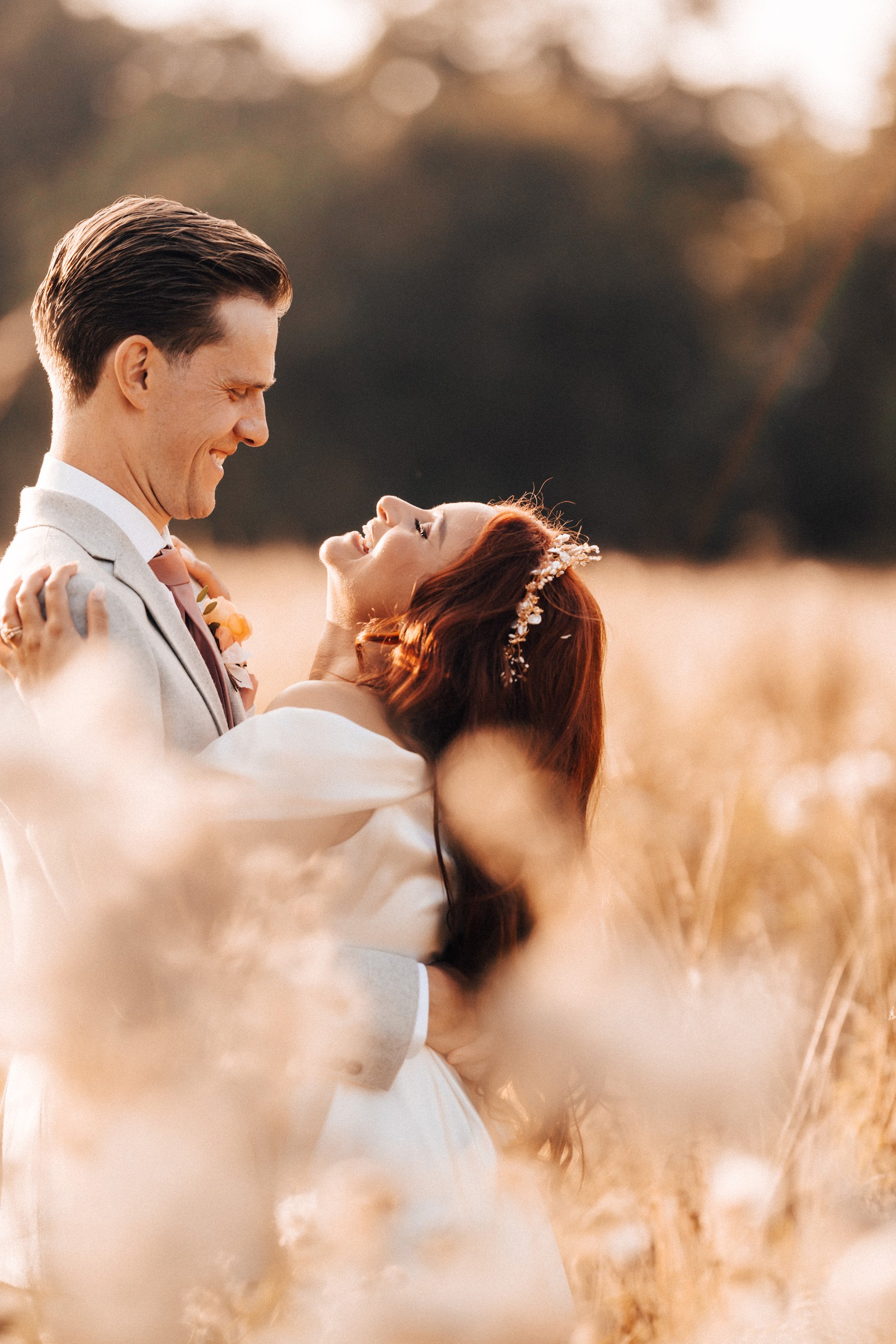 Golden hour bride and groom in the September sunshine fields at elmore court