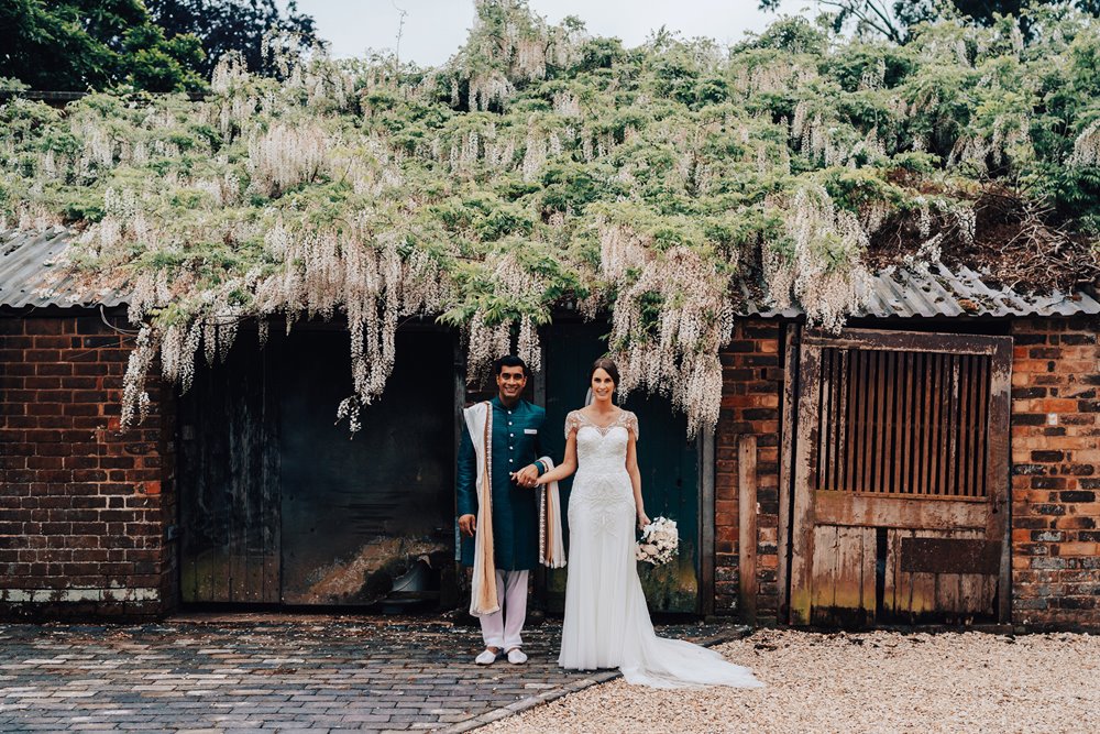 Beautiful blossom backdrop for the lovely newlyweds at their fusion wedding