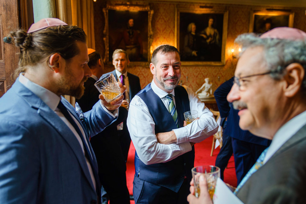 Jewish groomsmen celebrate tisch and drink whiskey at elmore court