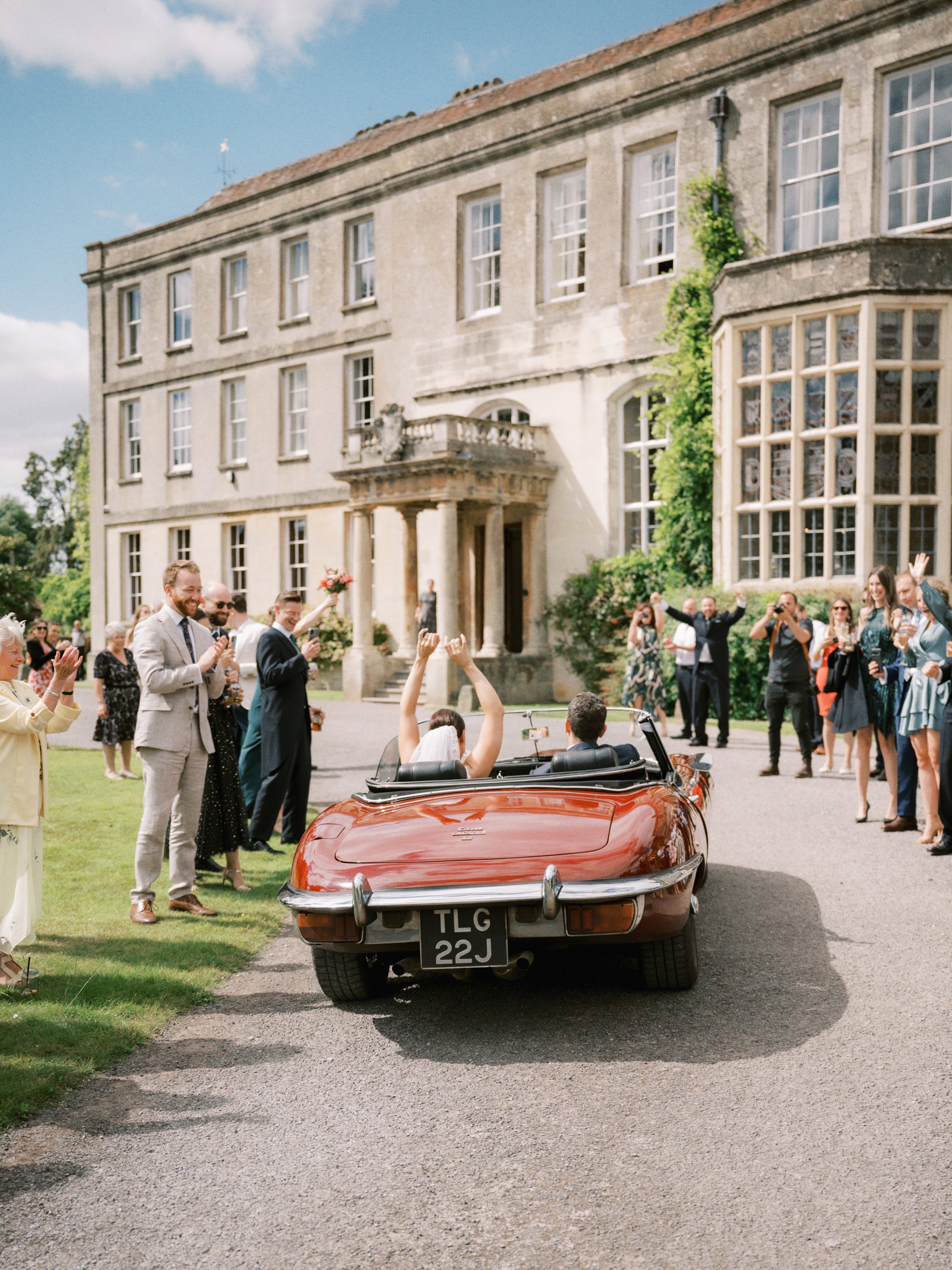 Newly wed couple arriving at Elmore Court in a snazzy classic car