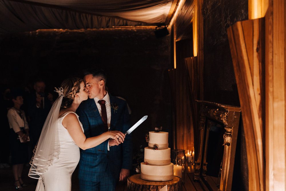 bride and groom cutting their christmas wedding cake