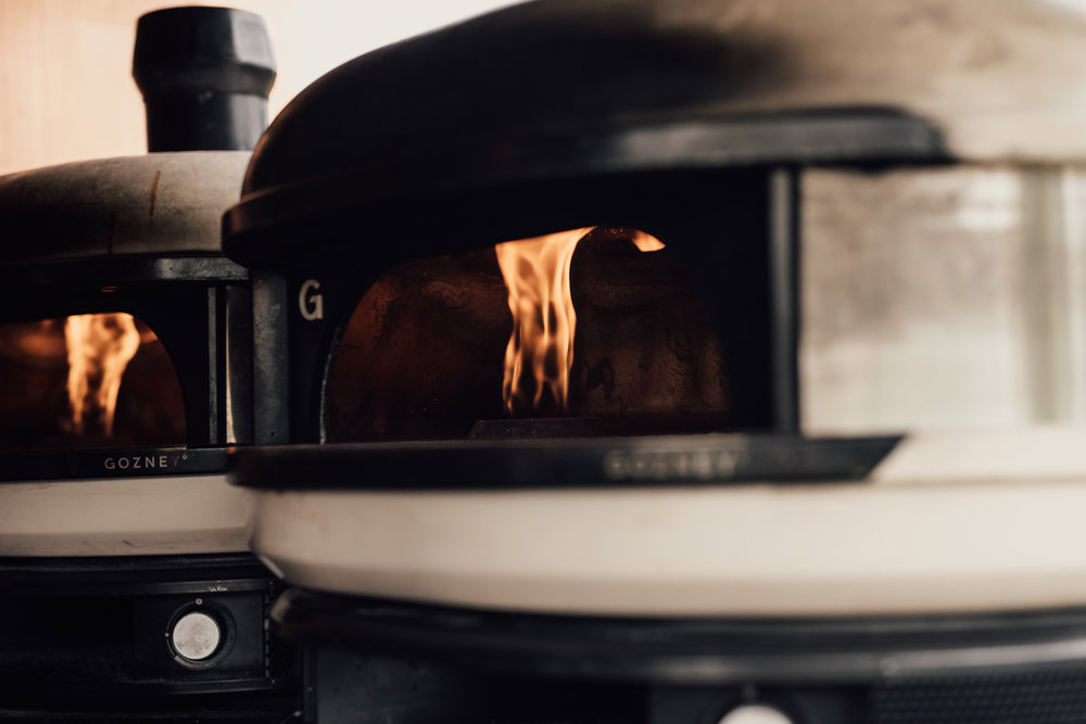 Wedding pizza from a cool truck with light up sign at wedding fair in the cotswolds