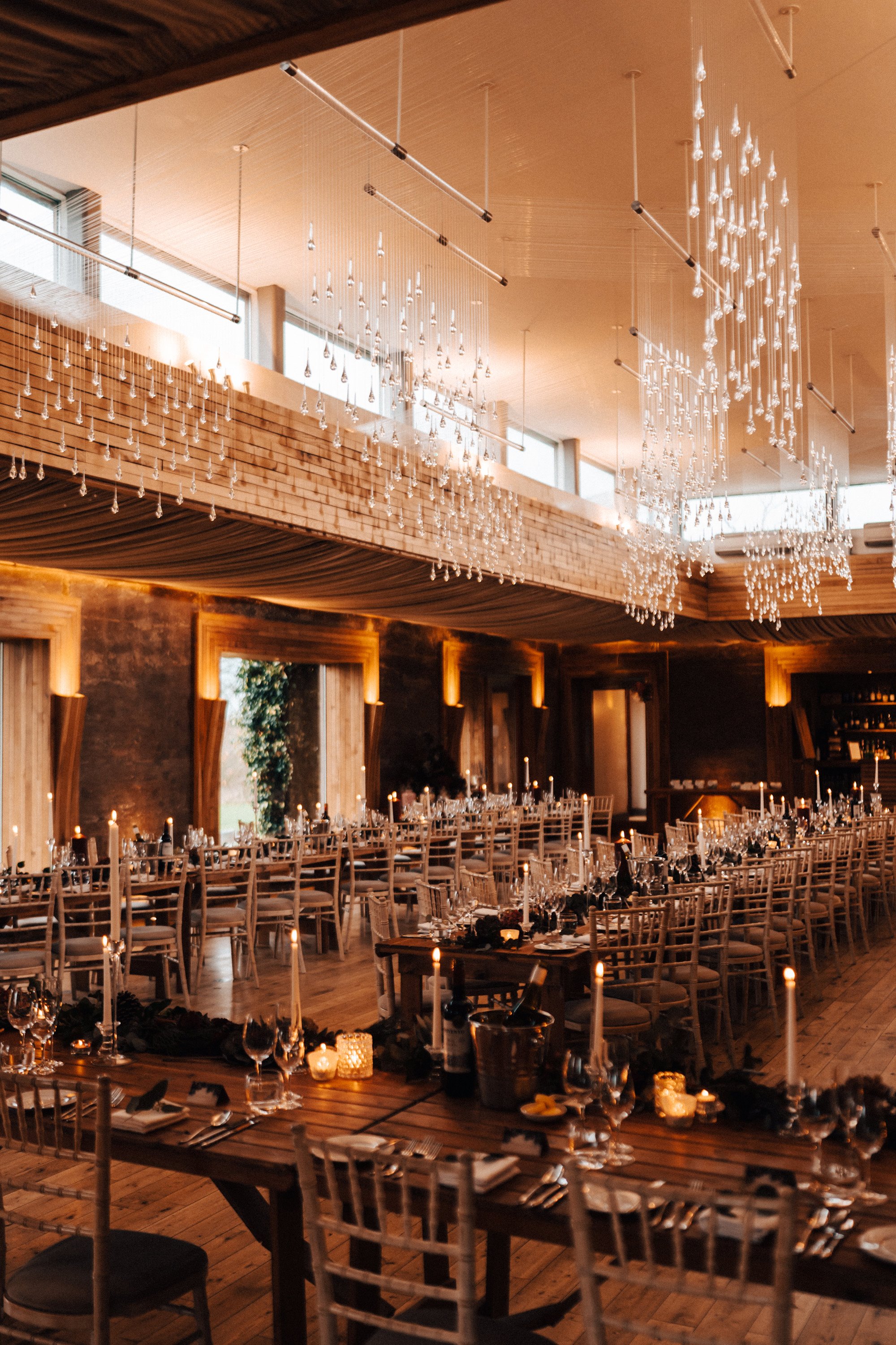 Winter wonderland wedding reception with hundreds of candles and twinkling lights in the cotswolds