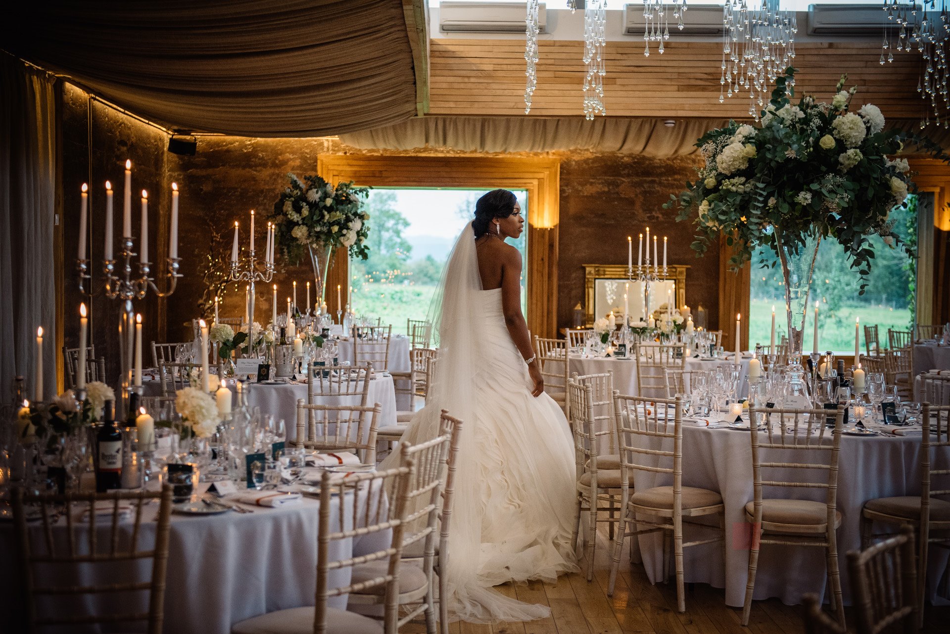 Bride sees her beautiful wedding reception tables all set out for the first time at elmore court