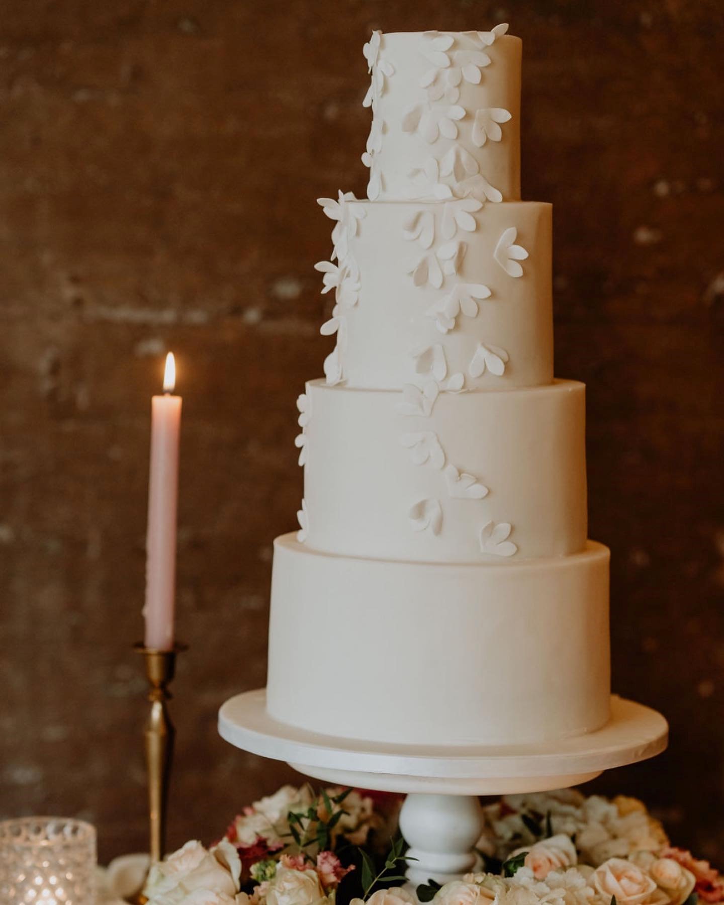 White wedding cake with elegant white florals in icing for a luxury wedding in the cotswolds