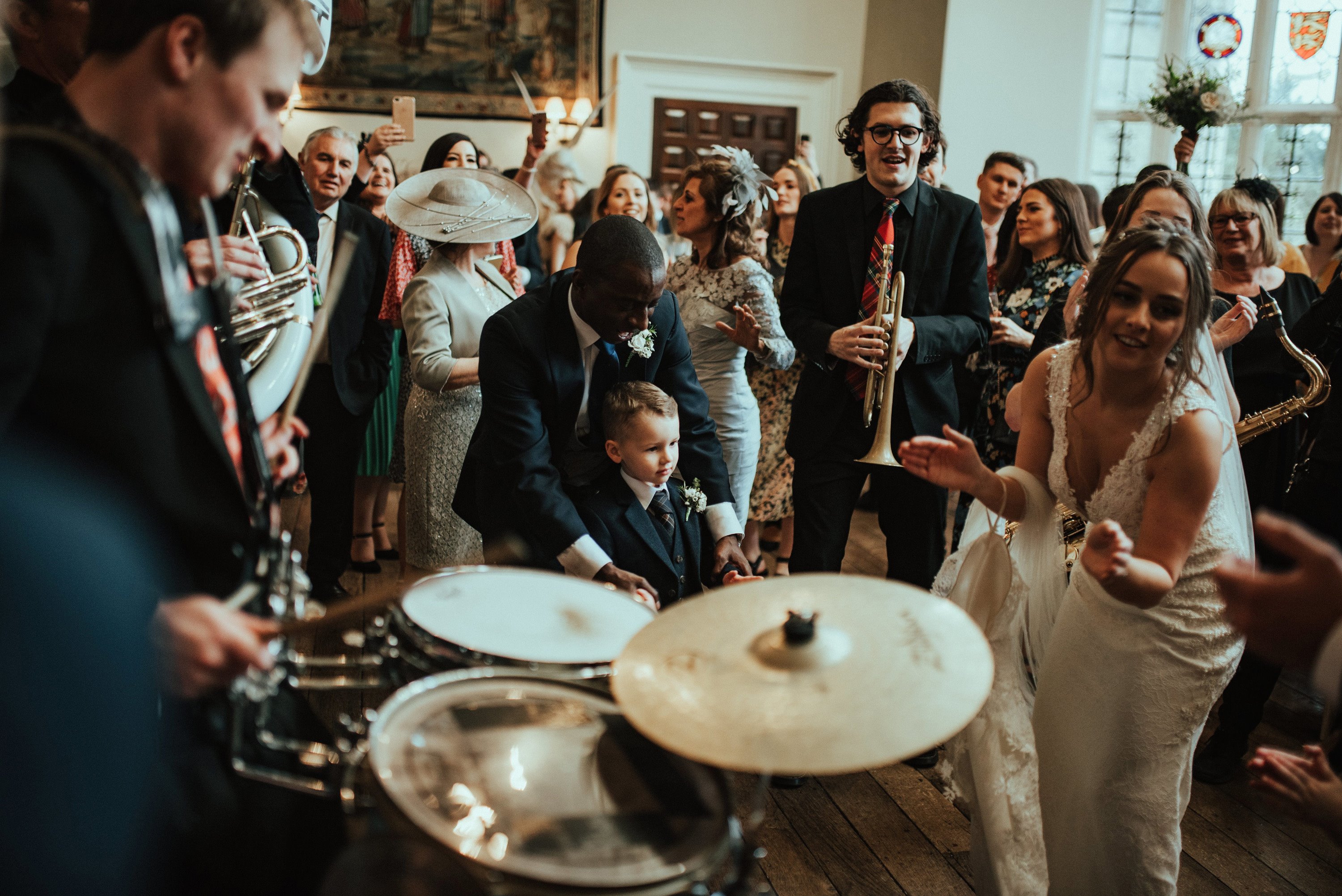 Outdoor wedding entertainment brought inside at a winter wedding. Bride dances to live band inside the hall at elmore court