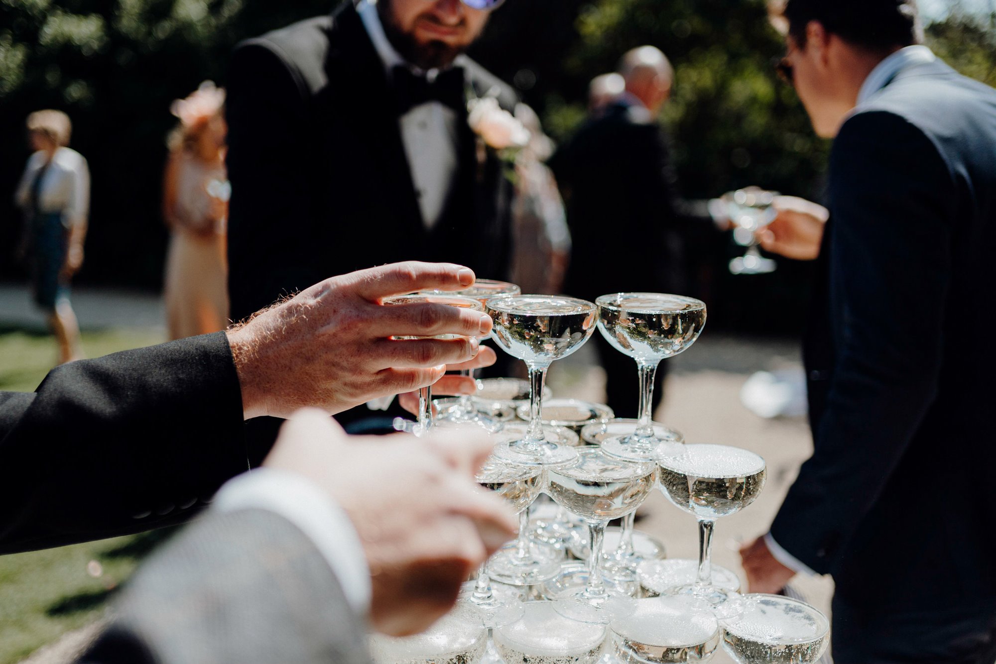 wedding guests toasting next to a champagne tower at Elmore Court