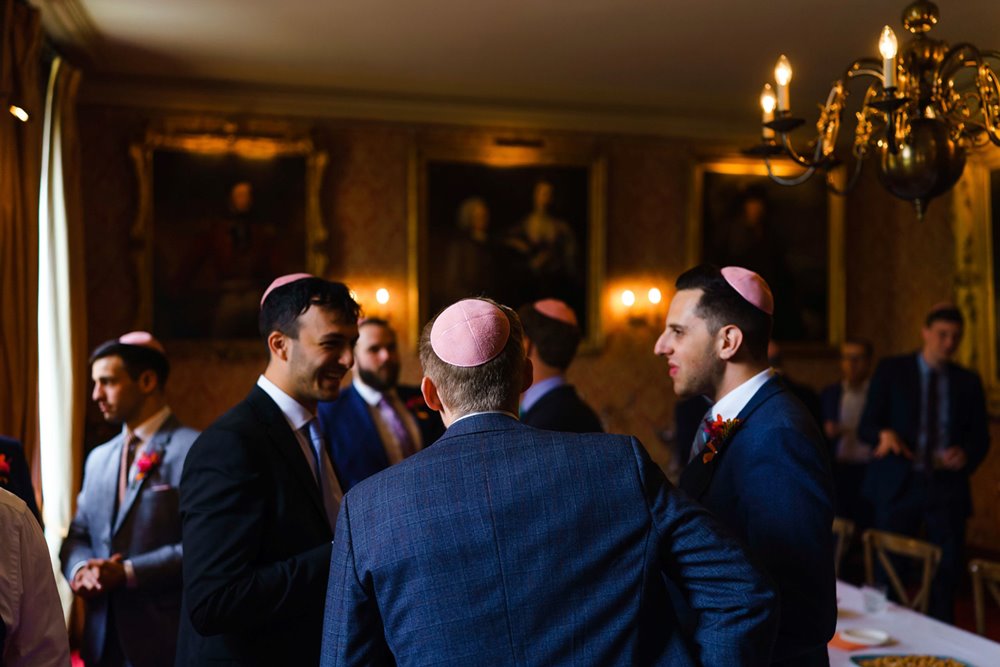 Jewish men in kippot at tish ceremony