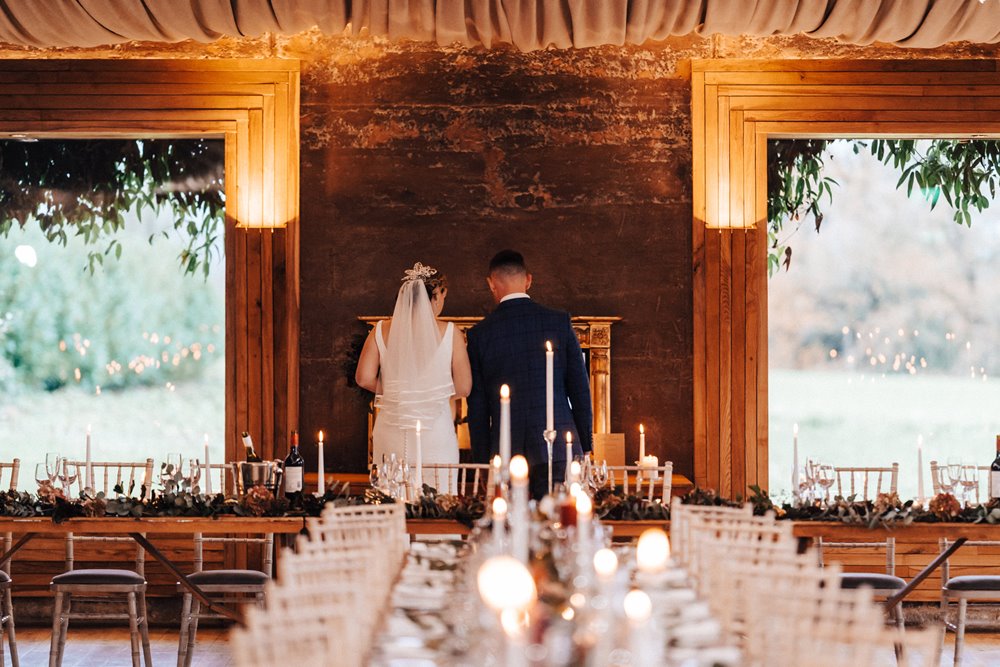 bride and groom first look at their winter wedding reception set up before their guests