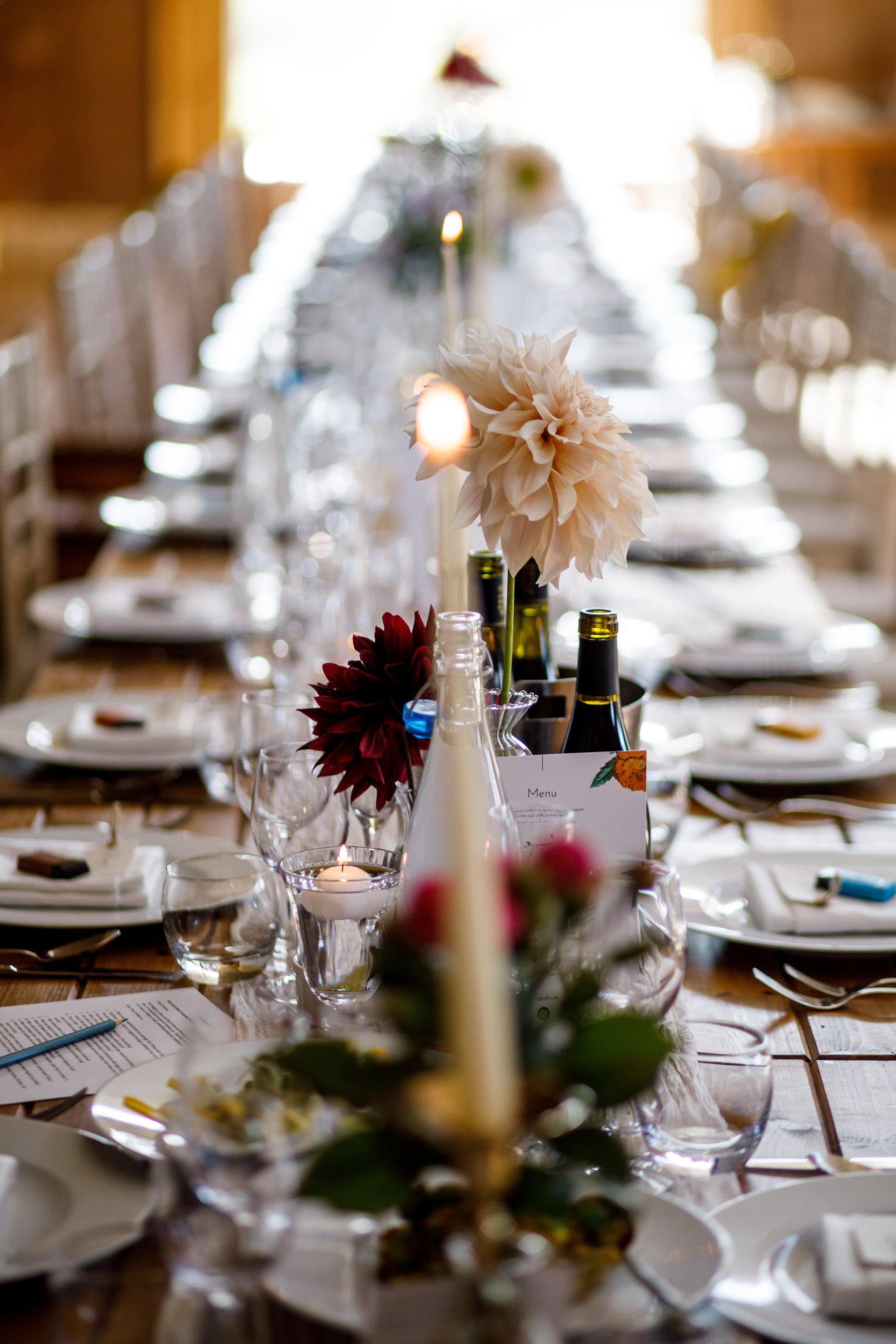 Long Candlelit table with flowers for a gay wedding reception in the UK