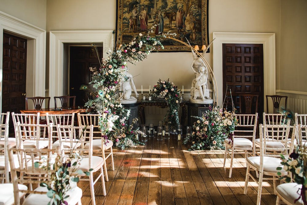 Wedding arch and floral decor in the beautiful sunny hall at Elmore Court ready for ceremony of 3 day wedding