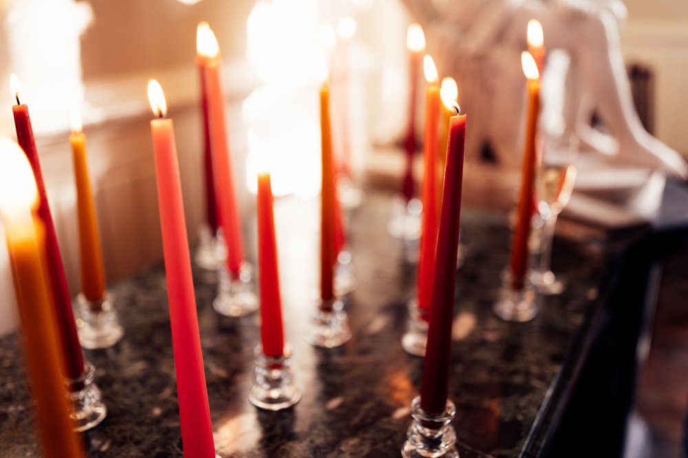 red and orange wedding candles for fun wedding theme