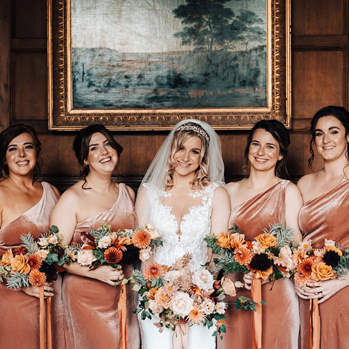 Stunning bridal party in with beautiful bouquets of autumnal coloured flowers