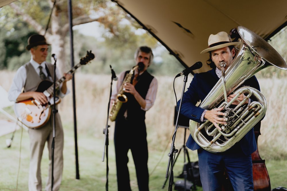 cool wedding band playing under stretch tent at festival wedding fair at elmore court in gloucester