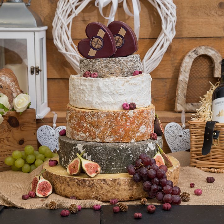 Tower of wedding cake made from gourmet cheeses