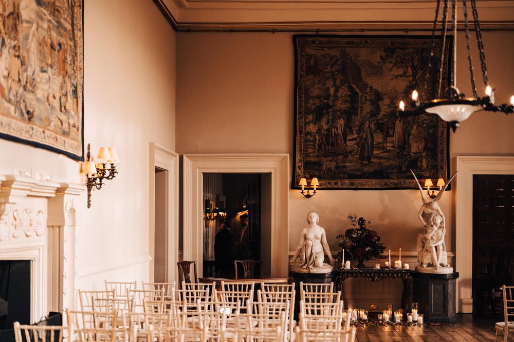 beautiful stately home winter wedding venue set up with candles and christmas flowers 