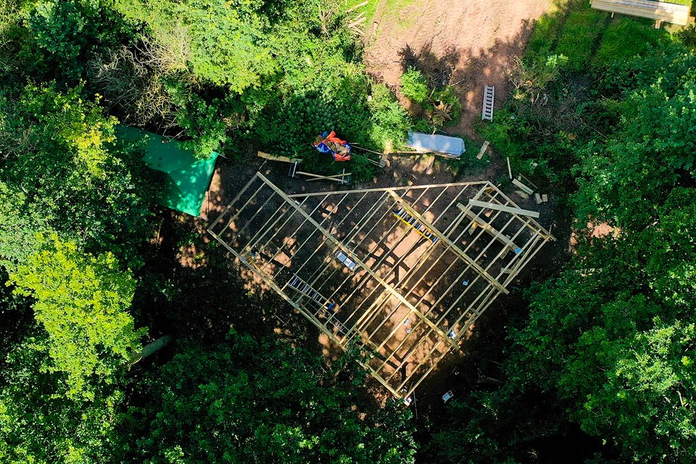 Ariel view of the decking of a treehouse in construction; nestled in a beautiful Cotswold woodland