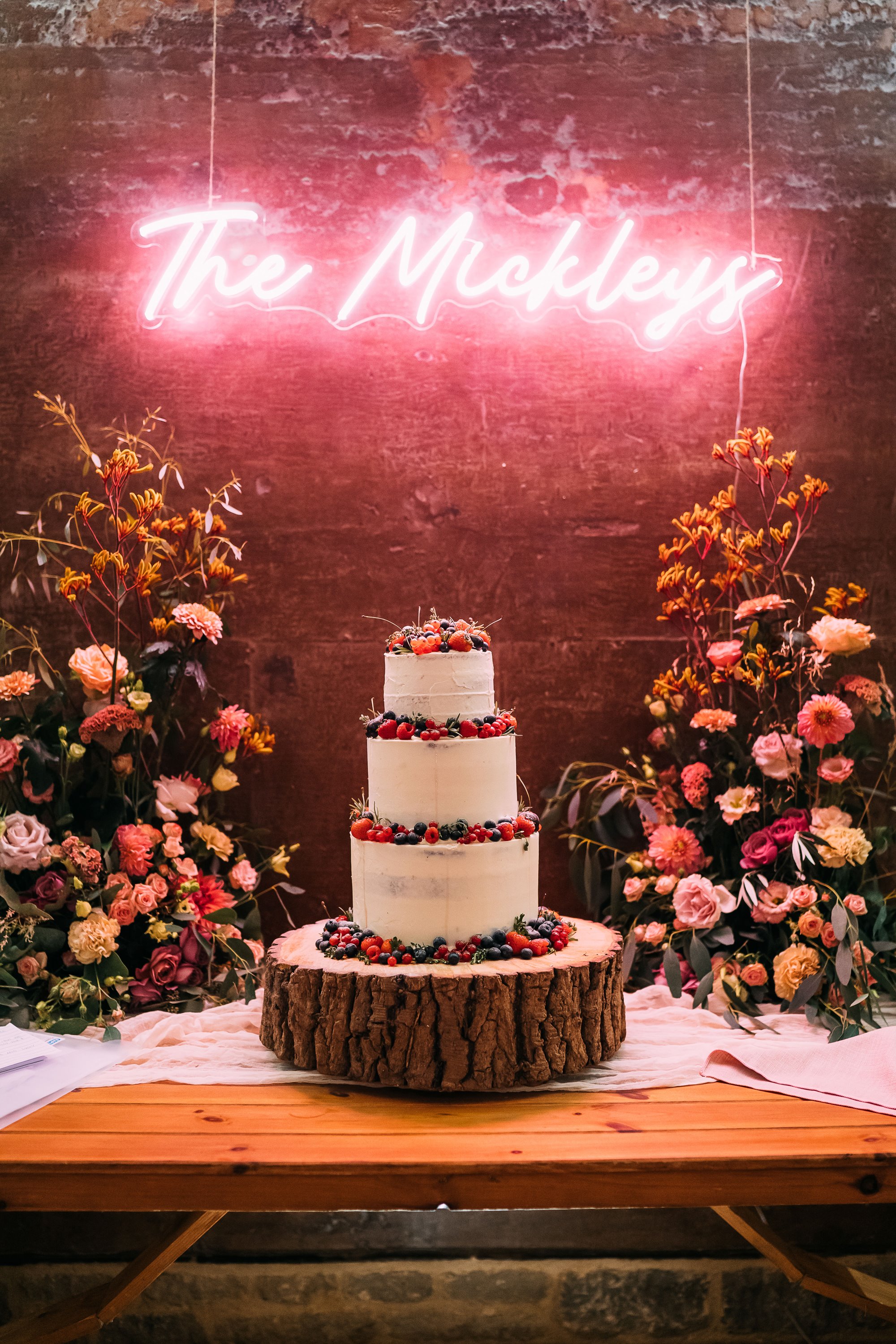 flower display around a wedding cake at Elmore Court