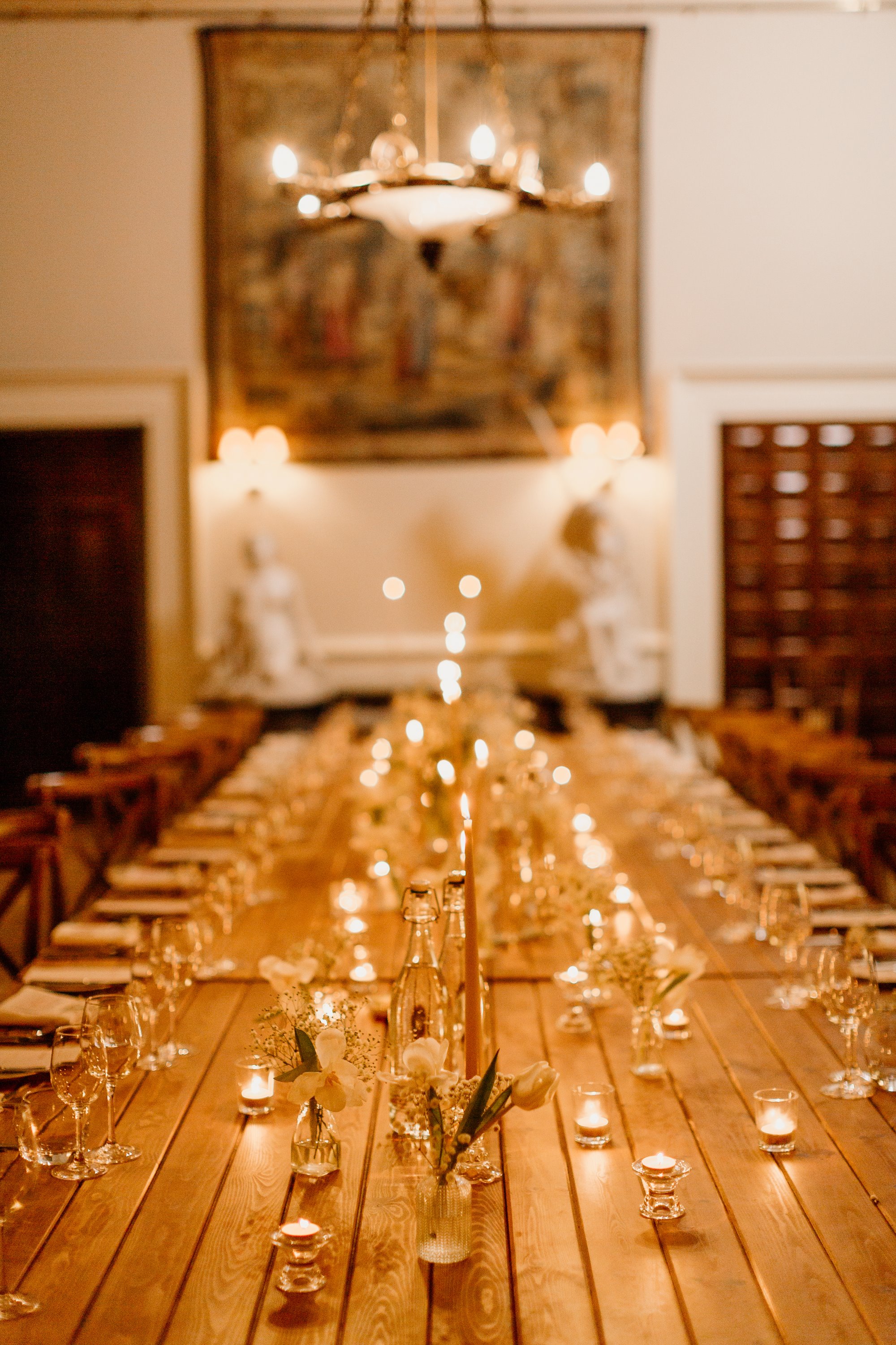 stunning table setting with candles and flowers in the great hall at Elmore court