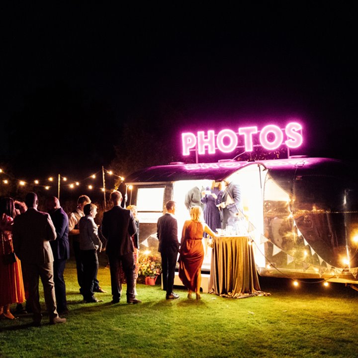 cool silver stream caravan photo booth with pink neon sign for festival weddings at elmore court in the cotswolds