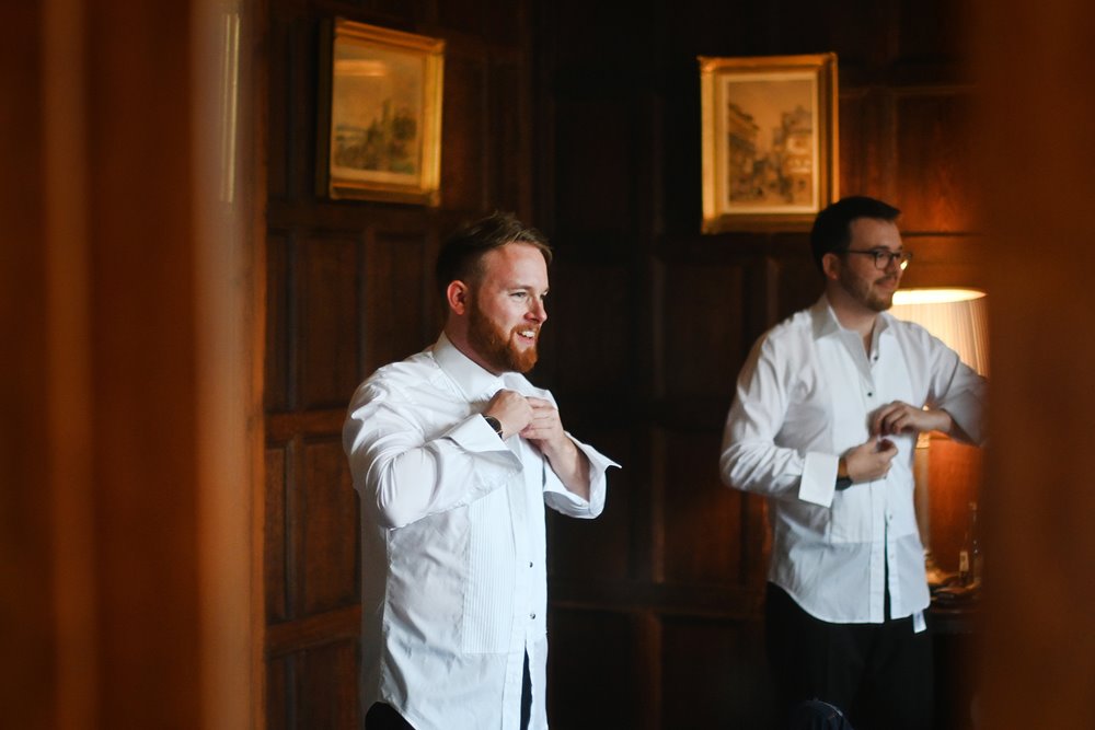 groom getting ready for autumnal wedding in a stately home