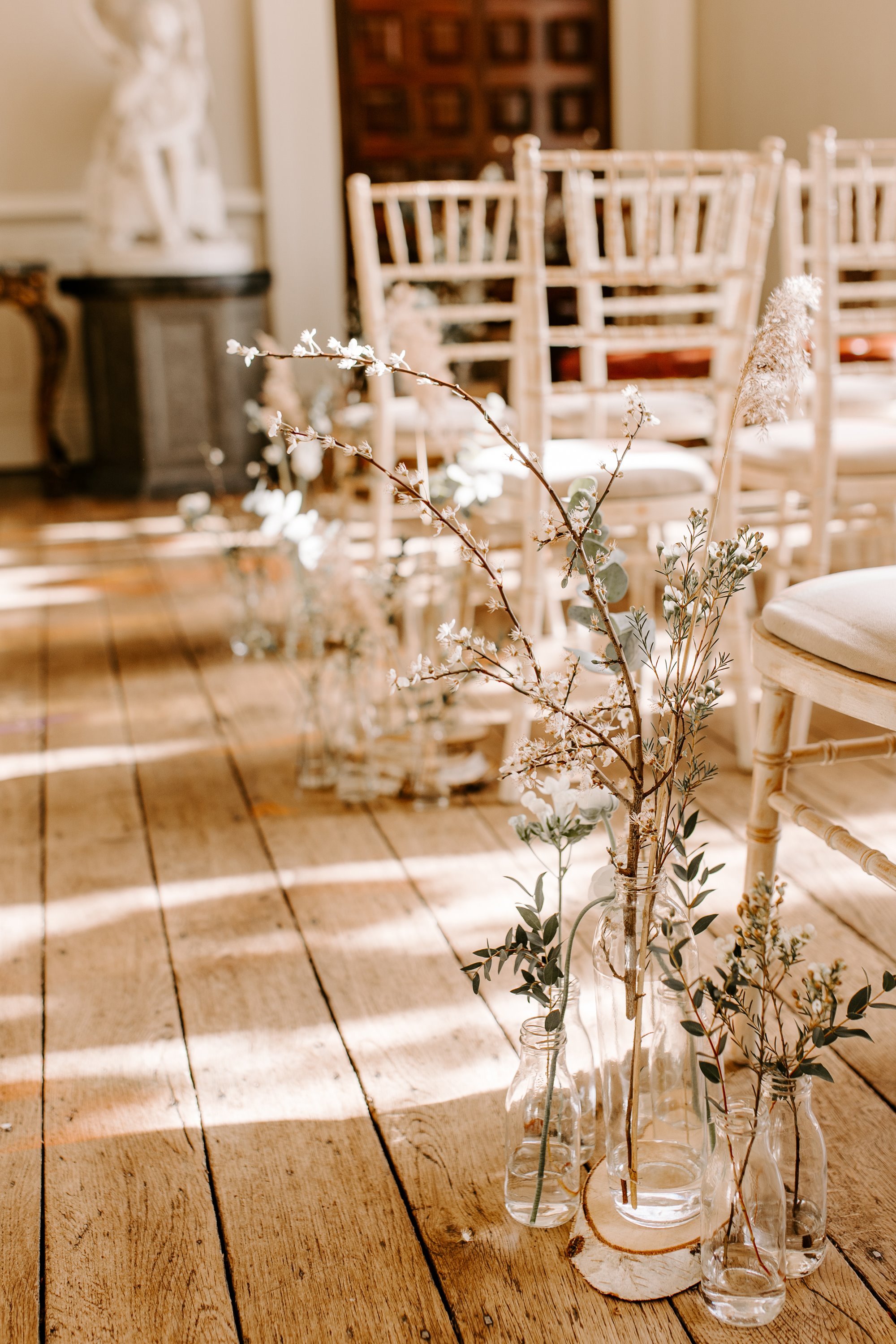 rustic wedding flowers on the floor of the aisle at a wedding ceremony